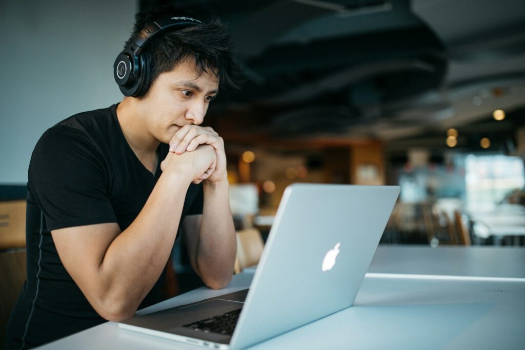 Person in headphones learning at MacBook