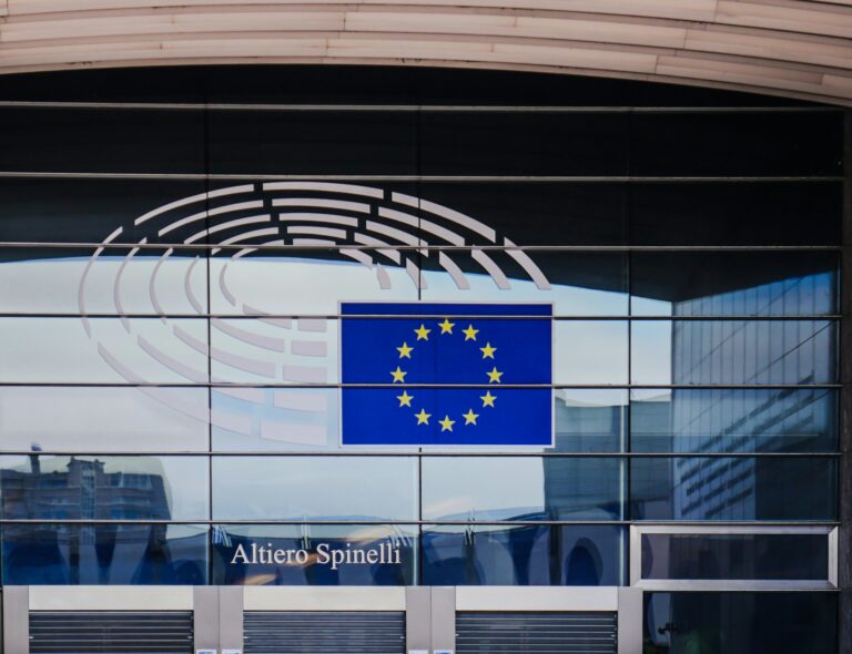 European Parliament building with EU flag and glass facade