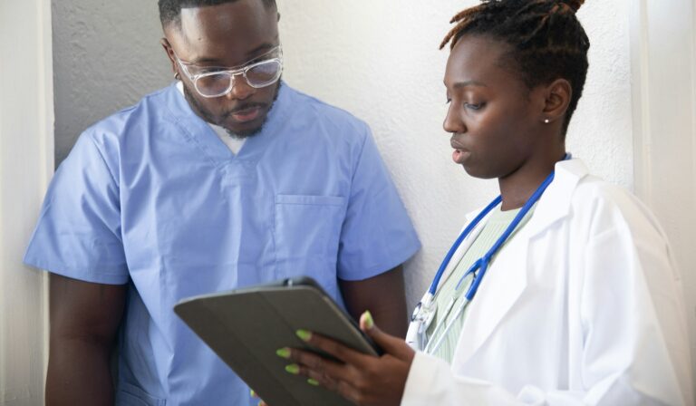 Doctor showing a patient information on a tablet in a clinical setting