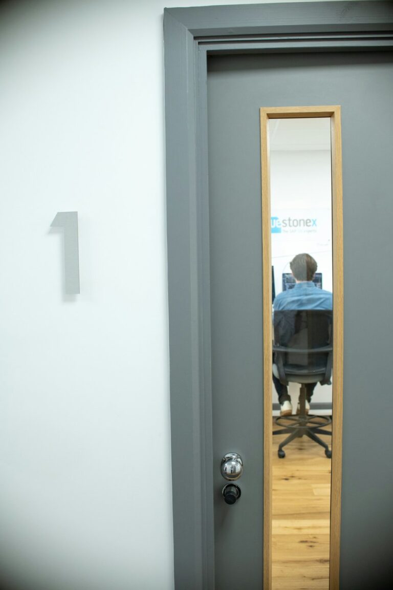 Office worker using a computer in an office, illustrating staff access controls and insider misuse risk