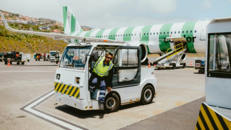 Airport assistance vehicle near an aircraft, illustrating assisted-travel health data handling
