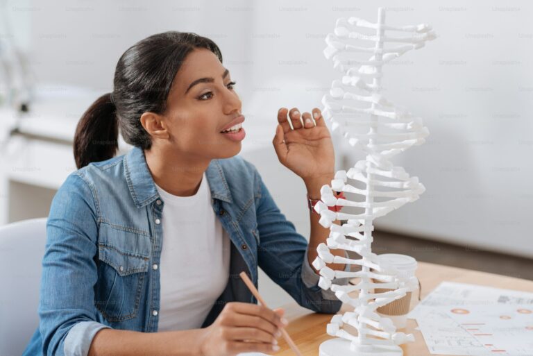Researcher studying a DNA model in a laboratory setting
