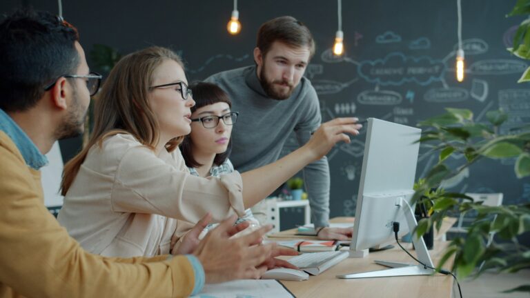 Team collaborating around a computer during workplace data protection training
