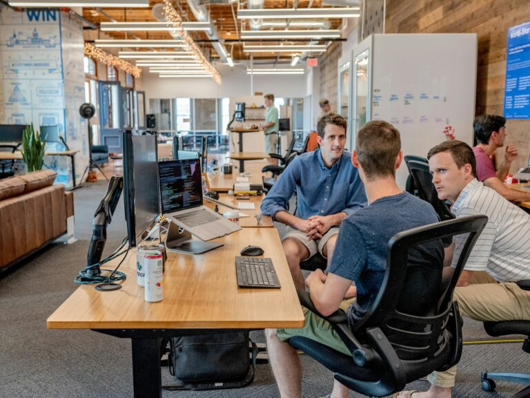 Colleagues in an office meeting discussing staff training