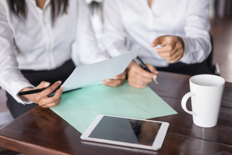 Colleagues reviewing documents together at a desk
